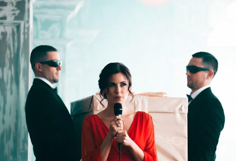 THE EX-WIFE CAME TO MY WEDDING IN RED, AND EVERYONE TOLD ME NOT TO LOOK AT HER. MY GROOM SAID SHE WAS BITTER, JEALOUS, AND DESPERATE TO RUIN HIS HAPPINESS. BUT WHEN TWO MEN CARRIED IN A GIANT WHITE BOX MEANT ONLY FOR ME, HIS HAND CLOSED AROUND MY WRIST LIKE FEAR HAD FINALLY FOUND HIM
